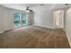 Large bedroom with neutral carpet, ceiling fan, and multiple windows at 18122 Sugar Brooke Dr, Tampa, FL 33647