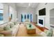 Bright living room features vaulted ceilings, fireplace, and sliding glass doors to pool at 18122 Sugar Brooke Dr, Tampa, FL 33647