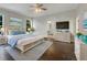 Comfortable main bedroom with TV, ceiling fan, and ensuite bathroom at 18122 Sugar Brooke Dr, Tampa, FL 33647