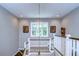 View of the staircase with white railings, wood steps, and decorative wall art at 18614 Hanna Rd, Lutz, FL 33549