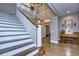 Elegant staircase with white risers and dark wood treads in a spacious foyer at 18614 Hanna Rd, Lutz, FL 33549