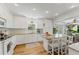 Renovated kitchen, featuring white shaker cabinets, granite countertops, and an island at 29249 Wilpayne Rd, Brooksville, FL 34602