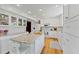Bright white kitchen with granite island, stainless steel appliances, and ample cabinetry at 29249 Wilpayne Rd, Brooksville, FL 34602
