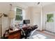 Home office with exterior access, hardwood floors and a large desk at 29249 Wilpayne Rd, Brooksville, FL 34602