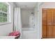 Updated bathroom with a shower/tub combo and a linen closet at 29249 Wilpayne Rd, Brooksville, FL 34602