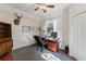 Spacious home office with built-in shelving, hardwood floors, and a ceiling fan at 29249 Wilpayne Rd, Brooksville, FL 34602