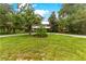 Landscaped lawn, gravel driveway, and two story house at 29249 Wilpayne Rd, Brooksville, FL 34602
