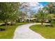 Lovely farmhouse with a circular driveway and lush landscaping at 29249 Wilpayne Rd, Brooksville, FL 34602