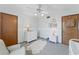 Bright bedroom with a ceiling fan, dresser, and comfortable armchair at 29249 Wilpayne Rd, Brooksville, FL 34602