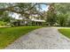House with a gravel driveway and lush green lawn at 29249 Wilpayne Rd, Brooksville, FL 34602