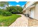 Large brick patio perfect for outdoor dining, adjacent to a fire pit and lush green lawn at 29249 Wilpayne Rd, Brooksville, FL 34602