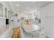 Updated kitchen with white cabinets, granite counters and island at 29249 Wilpayne Rd, Brooksville, FL 34602
