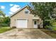Tan coloured detached garage with a white door and double garage door at 29249 Wilpayne Rd, Brooksville, FL 34602