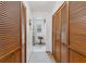 Long hallway with built-in wooden closets leading to the bathroom at 29249 Wilpayne Rd, Brooksville, FL 34602