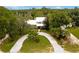 Stunning aerial view of a farmhouse with a large lot and circular driveway at 29249 Wilpayne Rd, Brooksville, FL 34602