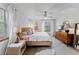 King-size bed, mid-century dresser, and plenty of natural light at 29249 Wilpayne Rd, Brooksville, FL 34602