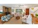 Cozy living room featuring hardwood floors, brick fireplace, and comfy seating at 29249 Wilpayne Rd, Brooksville, FL 34602