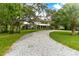 Large house with a long gravel driveway and green lawn at 29249 Wilpayne Rd, Brooksville, FL 34602