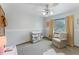 Bright bedroom with a ceiling fan, dresser, and comfortable armchair at 29249 Wilpayne Rd, Brooksville, FL 34602