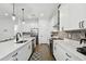 Modern kitchen with white cabinets, quartz countertops, and stainless steel appliances at 807 W Kentucky Ave, Tampa, FL 33603