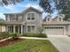 Two-story house featuring a gray exterior, large windows, and a double-car garage at 18122 Sugar Brooke Dr, Tampa, FL 33647