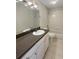 Updated bathroom with dark countertop and shower at 18122 Sugar Brooke Dr, Tampa, FL 33647