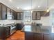 Modern kitchen with dark cabinets and a large island at 18122 Sugar Brooke Dr, Tampa, FL 33647