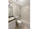 Clean bathroom with a tub, toilet and sink at 18122 Sugar Brooke Dr, Tampa, FL 33647