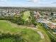 Aerial view showcasing property's location near a golf course, homes, and scenic surroundings at 13102 Prestwick Dr, Riverview, FL 33579