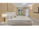 Comfortable bedroom features a large window, white bedding, and modern decor at 13102 Prestwick Dr, Riverview, FL 33579