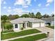 Charming single-story home features a well-manicured lawn and a three-car garage at 13102 Prestwick Dr, Riverview, FL 33579