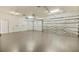 Spacious garage with a smooth floor and an automatic door at 13102 Prestwick Dr, Riverview, FL 33579