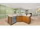 Open kitchen with wood cabinets, stainless steel appliances, and view to the Gathering room at 13102 Prestwick Dr, Riverview, FL 33579