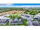 An aerial view of a community with lush green spaces, a pool, and well-maintained townhomes at 4844 Booth Bay Dr, New Port Richey, FL 34652