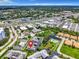 Aerial view of community featuring condominiums, a small pond with a pool, and nearby businesses at 4844 Booth Bay Dr, New Port Richey, FL 34652