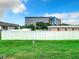 Backyard lawn enclosed by a white vinyl fence in front of an apartment building at 4844 Booth Bay Dr, New Port Richey, FL 34652