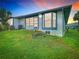 Backyard view of home with lush green lawn, mature trees and view of the property at 4844 Booth Bay Dr, New Port Richey, FL 34652