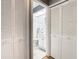 Bathroom view through closet doors, featuring neutral tile and a white vanity at 4844 Booth Bay Dr, New Port Richey, FL 34652