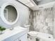 Bathroom featuring a walk-in shower, marble tiling, and modern fixtures at 4844 Booth Bay Dr, New Port Richey, FL 34652