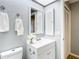 Bright bathroom featuring a white vanity, framed mirror, and fresh white towels at 4844 Booth Bay Dr, New Port Richey, FL 34652