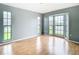 Bright bedroom with light wood floors and a large bay window at 4844 Booth Bay Dr, New Port Richey, FL 34652