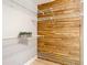 Walk in closet with wood wall featuring wire shelving and light wood floors at 4844 Booth Bay Dr, New Port Richey, FL 34652