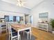 Bright dining room featuring a hardwood table and flooring adjacent to the kitchen, and lots of natural light at 4844 Booth Bay Dr, New Port Richey, FL 34652