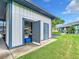 Exterior side view building showing storage filled with shelving and items, complemented by the well-maintained lawn at 4844 Booth Bay Dr, New Port Richey, FL 34652
