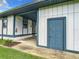 Exterior view featuring side of building with storage, an entry point, a manicured flower bed, and a green lawn at 4844 Booth Bay Dr, New Port Richey, FL 34652