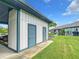 Exterior angle of a building with storage showcasing green lawn, plants, and nearby car port at 4844 Booth Bay Dr, New Port Richey, FL 34652