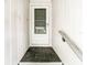 Front door with gray screen door and black tile landing at 4844 Booth Bay Dr, New Port Richey, FL 34652