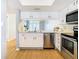 Kitchen featuring stainless steel appliances, white cabinetry, and wood flooring at 4844 Booth Bay Dr, New Port Richey, FL 34652