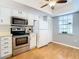 Bright kitchen with stainless appliances, white cabinets, and a window view at 4844 Booth Bay Dr, New Port Richey, FL 34652