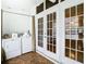 Laundry room featuring a washer and dryer, with French doors to the outside at 4844 Booth Bay Dr, New Port Richey, FL 34652